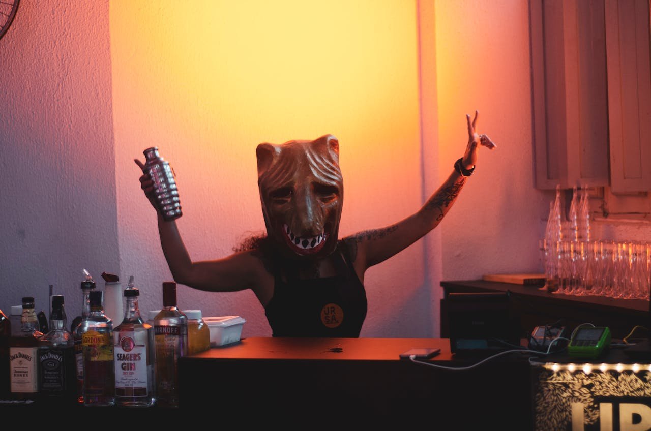 Person Wearing Mask Holding Cocktail Shaker